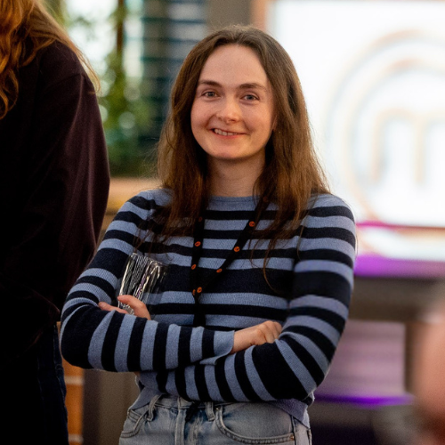 Emily, TV & Film Fusion , MasterChef runner, standing with arms folded at a creative industries networking event in the West Midlands.
